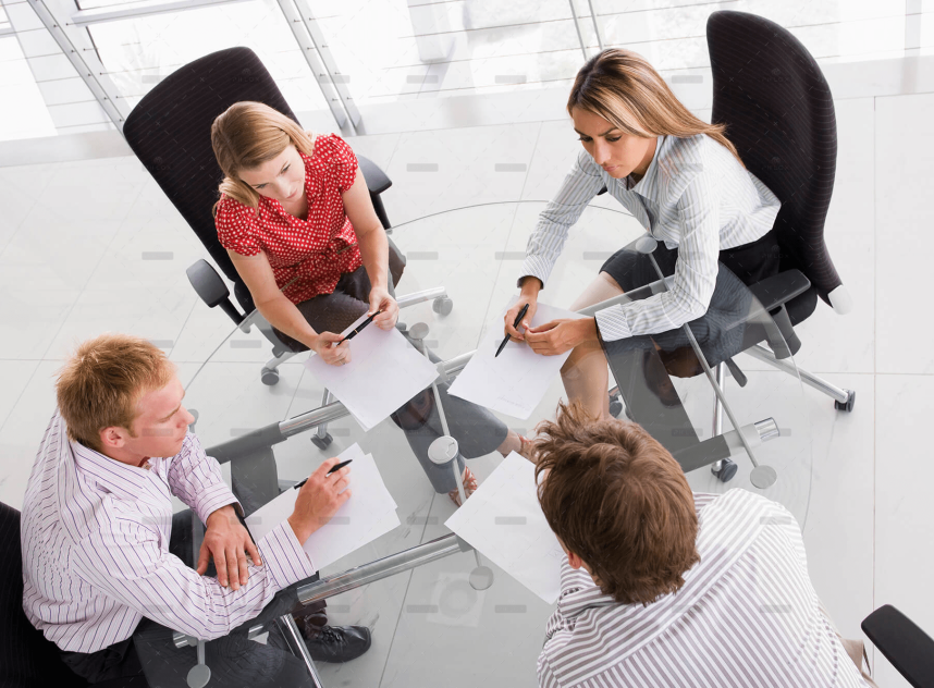 demo-attachment-458-four-businesspeople-in-a-boardroom-with-paperwork-PC4V8H4